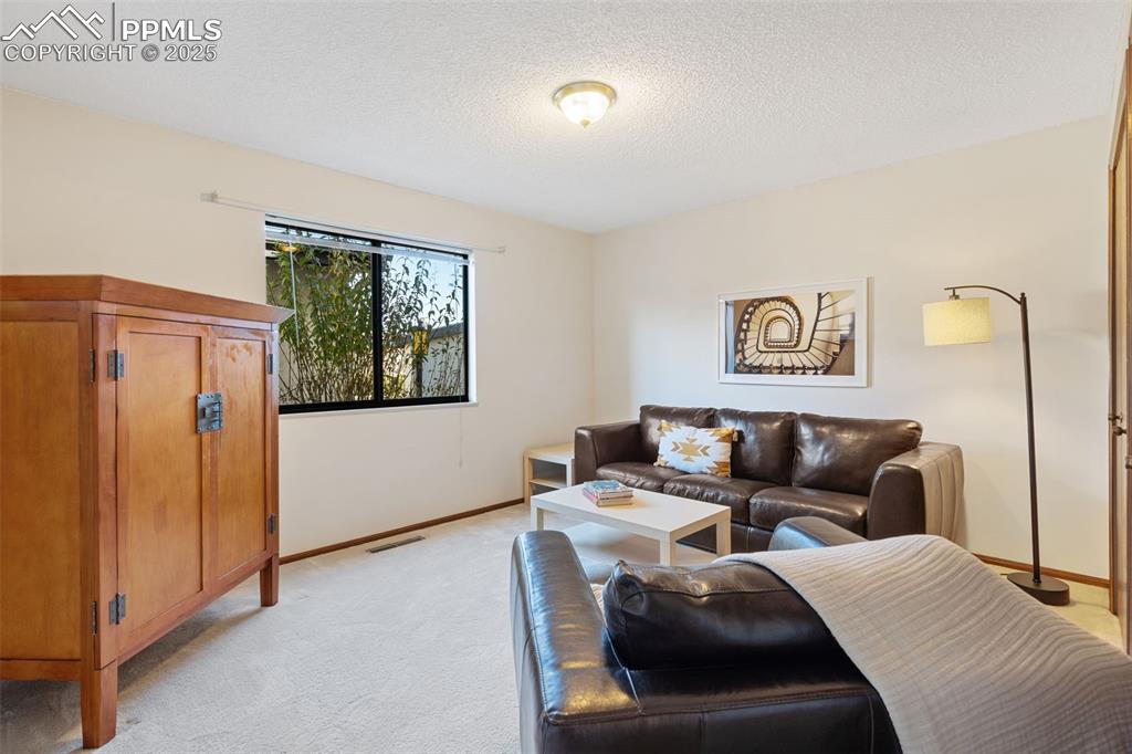 Image 26 of 28: Bedroom 3 is currently being used as a den.