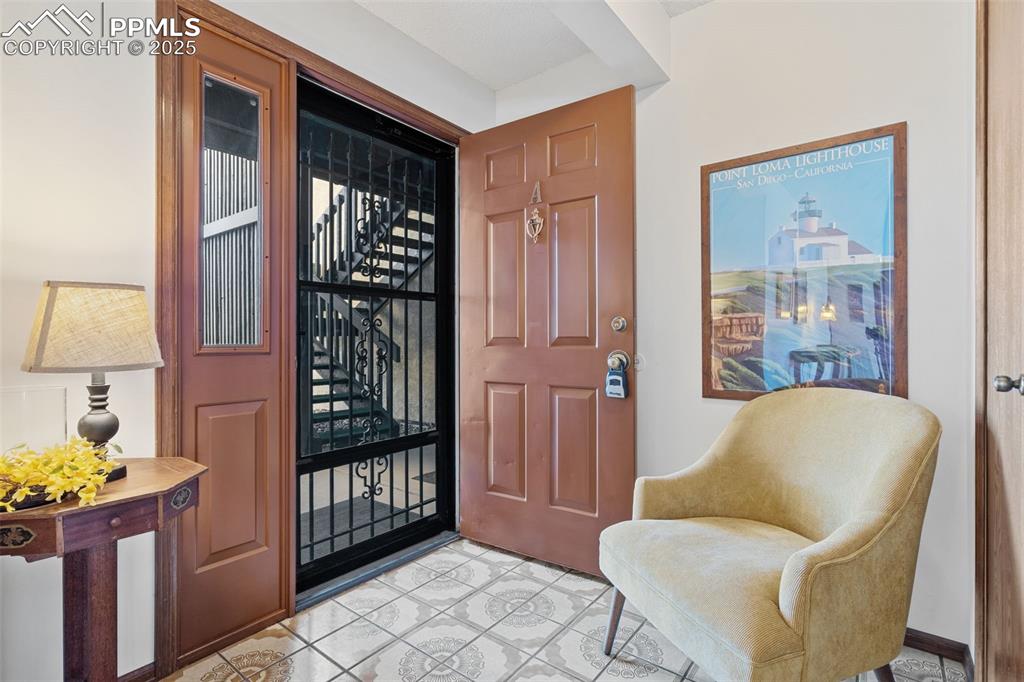 Image 3 of 28: Welcome in!!  The inviting entryway offers vintage tile and a convenient co