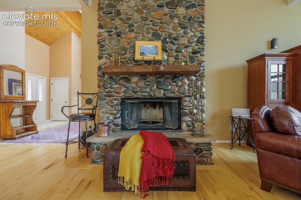 Image 10 of 50: Floor-to-ceiling river rock fireplace!