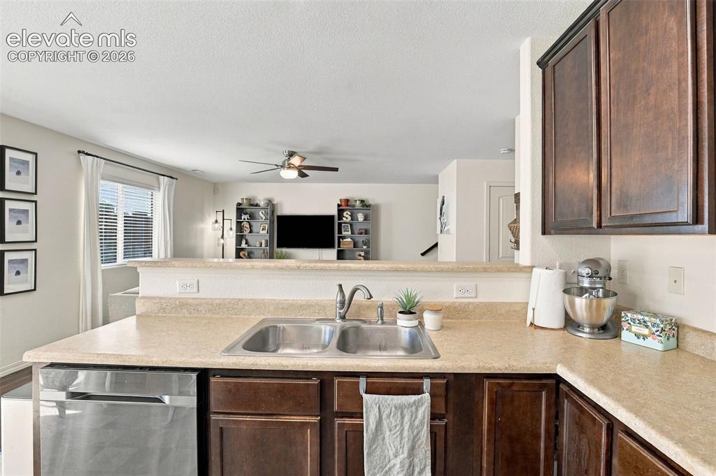 Image 16 of 48: Kitchen featuring a double stainless steel sink, a stainless steel dishwash