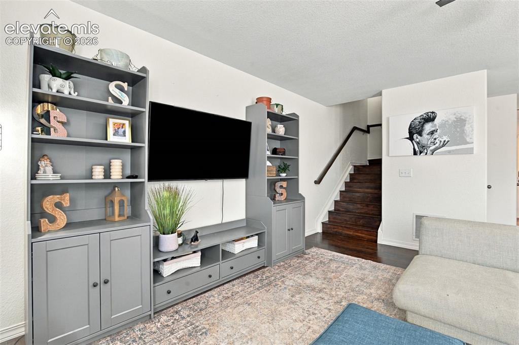 Image 23 of 48: Integrated media console with shelving and cabinet storage, wood-finish sta