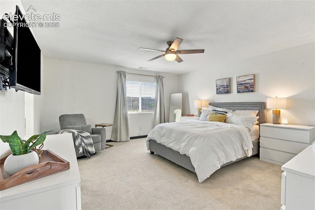 Image 24 of 48: Wall-mounted television with articulating bracket, ceiling fan with integra