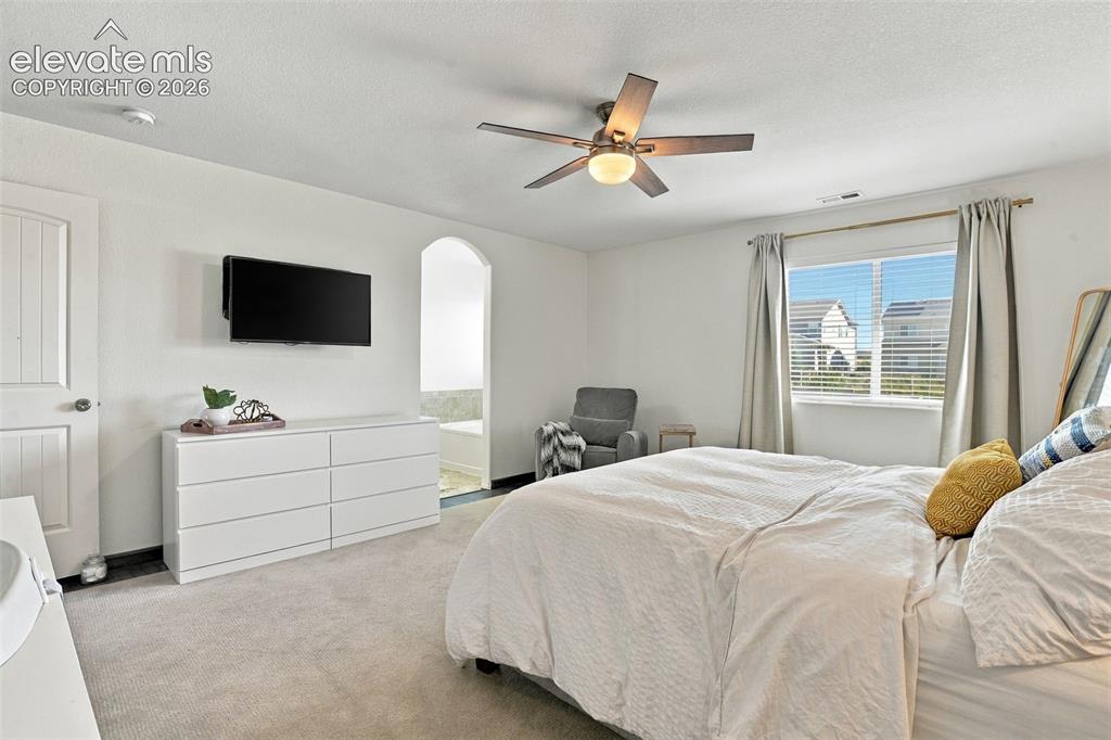 Image 25 of 48: Carpeted flooring, ceiling fan with integrated lighting, window with blinds