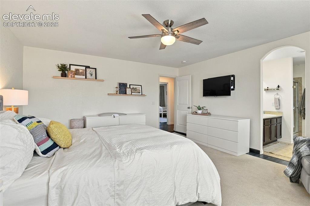 Image 26 of 48: Recessed lighting, ceiling fan with light fixture, arched doorway, vanity w