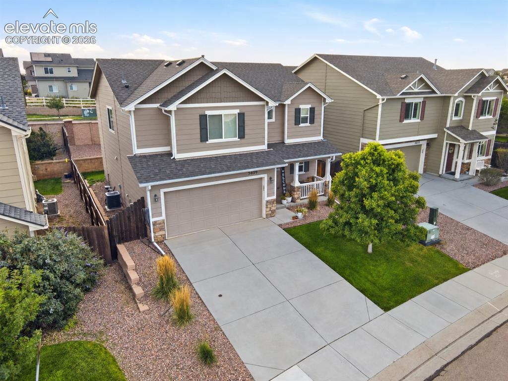Image 3 of 48: Two-story residence featuring a two-car garage, front porch with columns, a