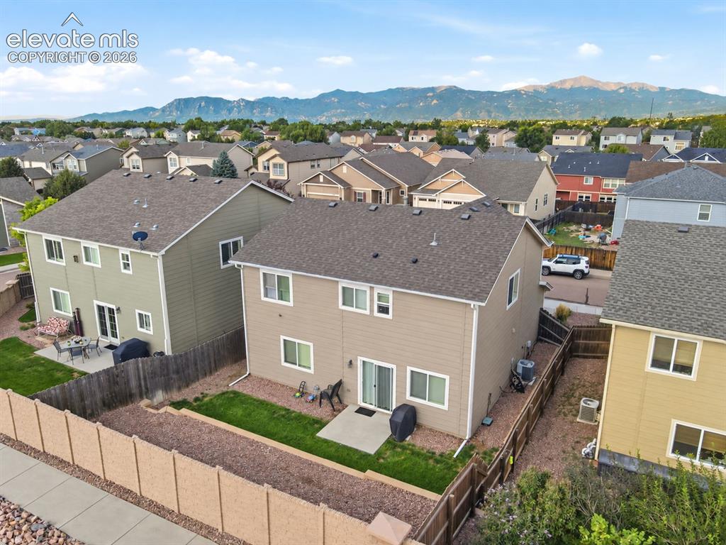 Image 38 of 48: Two-story residence with a composite shingle roof and neutral-toned siding