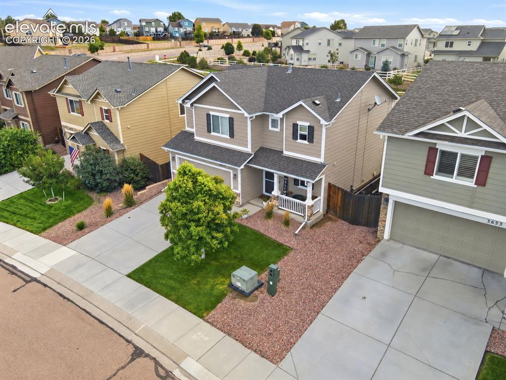 Image 4 of 48: Two-story residence featuring a covered front porch, an attached two-car ga