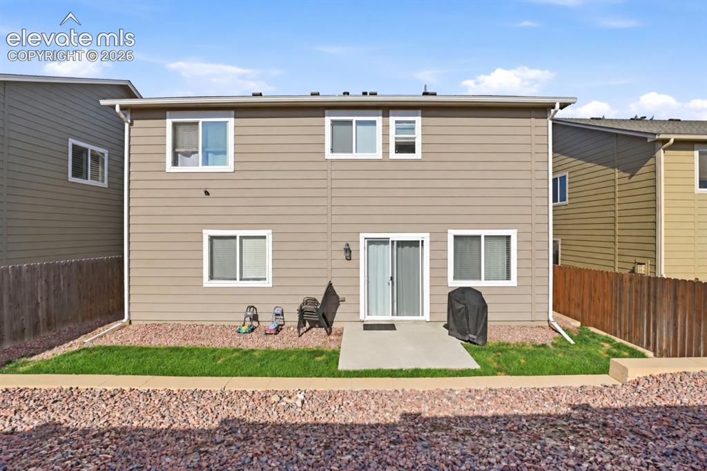 Image 40 of 48: Rear exterior with vinyl siding and multiple windows