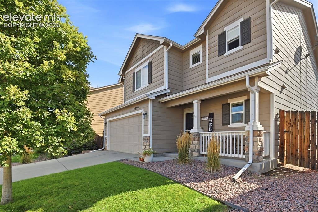 Image 5 of 48: Two-story exterior with neutral siding, an attached garage, a covered front
