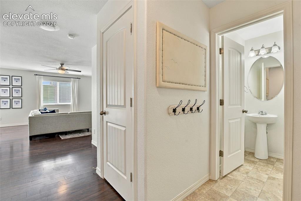 Image 6 of 48: Hardwood-finish flooring, ceiling fan, and panel doors
