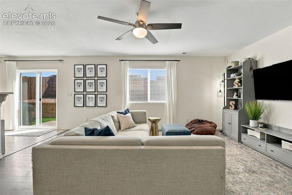 Image 8 of 48: Recessed lighting, ceiling fan, wood-finish flooring, sliding glass door, a