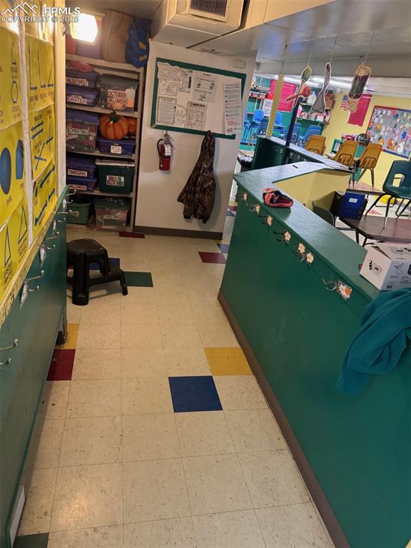 Image 20 of 33: Classroom with visible vents and tile patterned floors