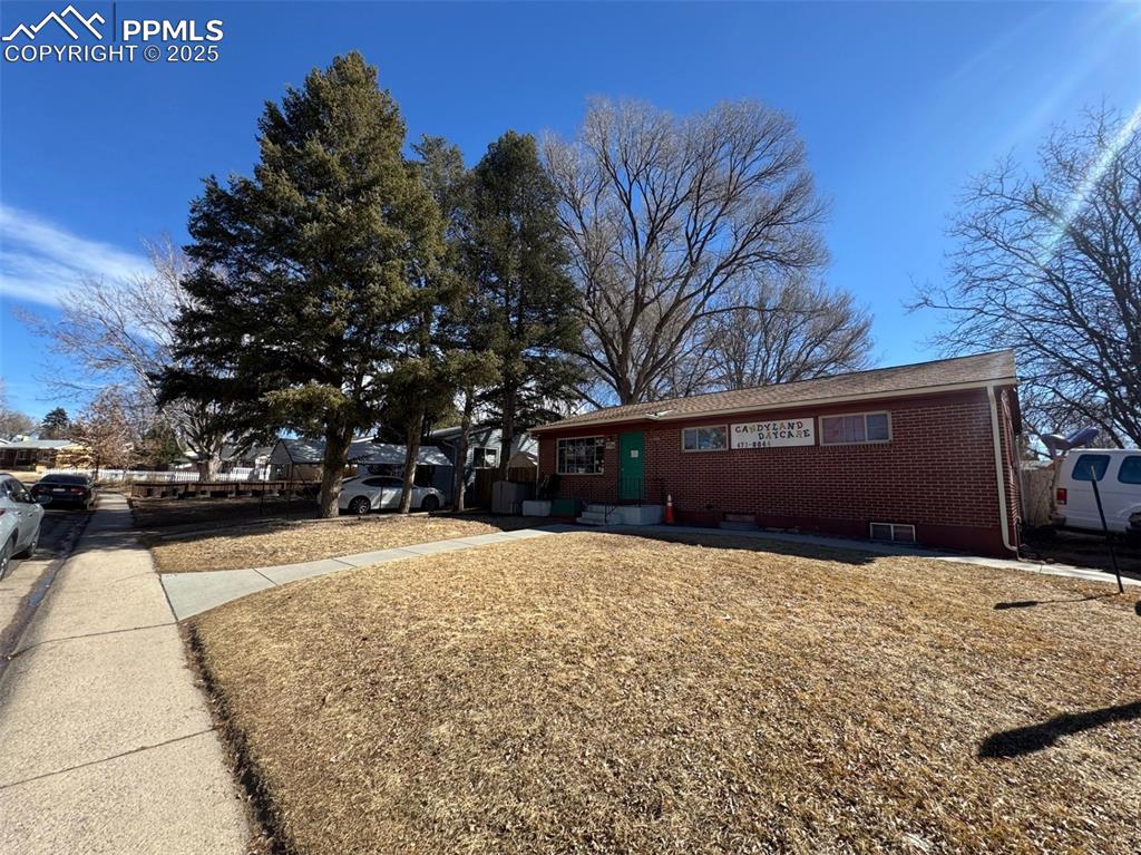 Image 3 of 33: Ranch-style house with brick siding and roof with shingles