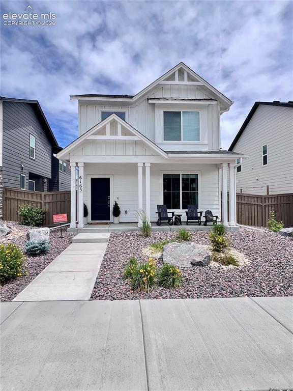 Caption: Contemporary two-story residence featuring white vertical and horizontal siding
