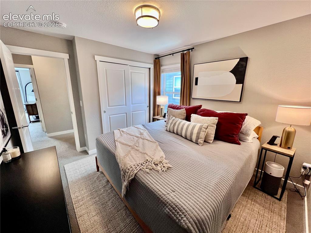 Image 14 of 20: Neutral tone wall finish with a built-in closet featuring bi-fold doors
