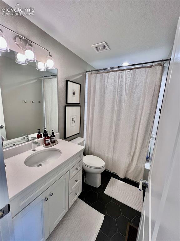 Image 15 of 20: Bathroom featuring a white vanity with an undermount sink and a light-toned