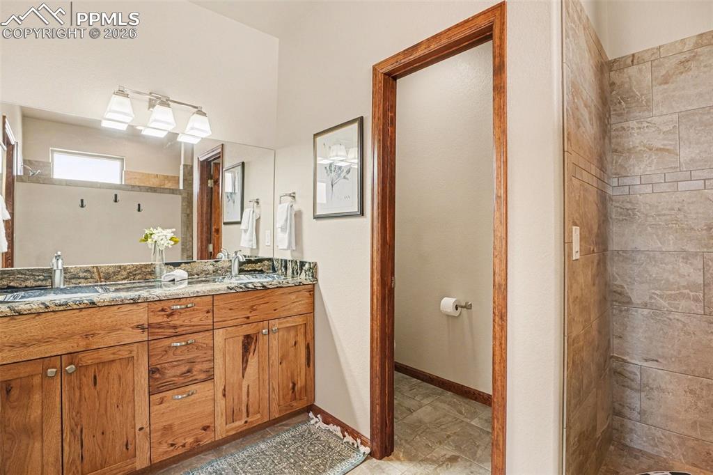 Image 18 of 35: The master bedroom adjoins a luxurious primary bathroom, creating a seamles