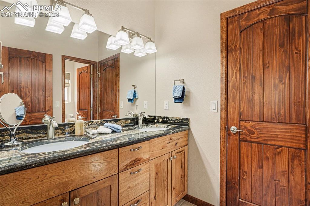 Image 21 of 35: The upstairs Jack and Jill bathroom is thoughtfully designed to be shared b
