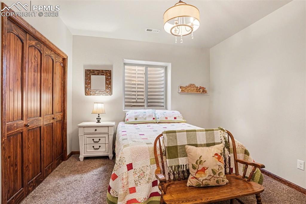 Image 26 of 35: The 1st basement bedroom provides a comfortable and private retreat, ideal 