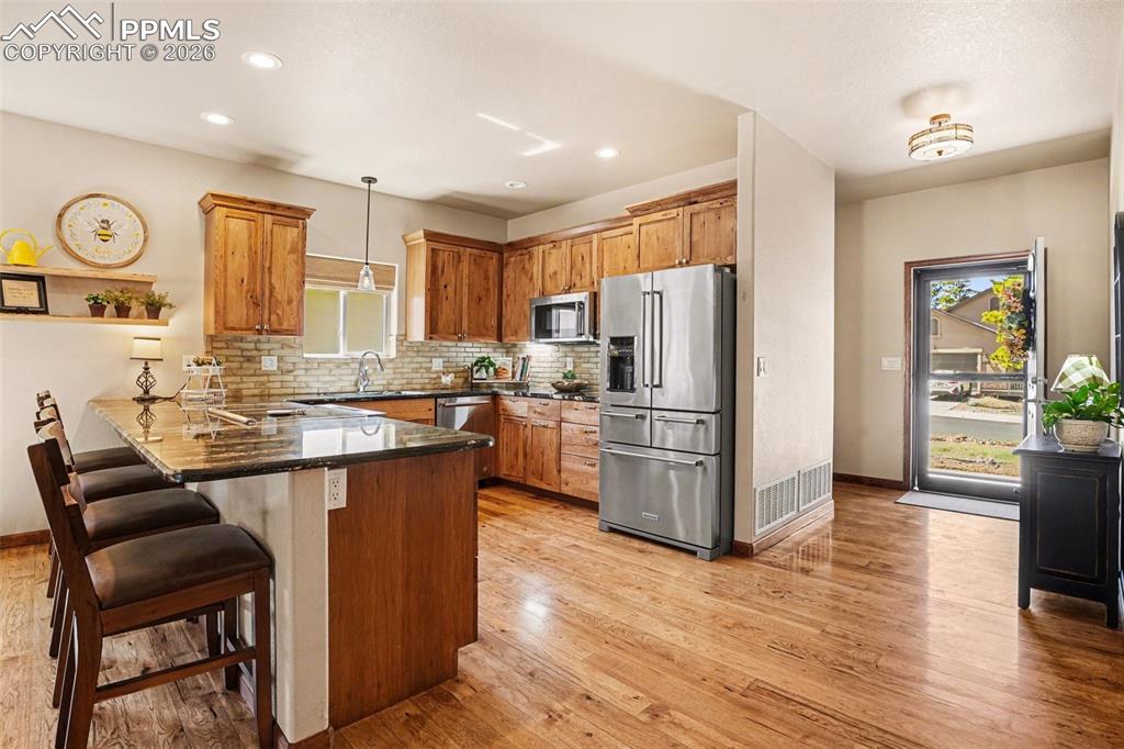 Image 5 of 35: The kitchen showcases gorgeous hickory cabinetry that perfectly complements
