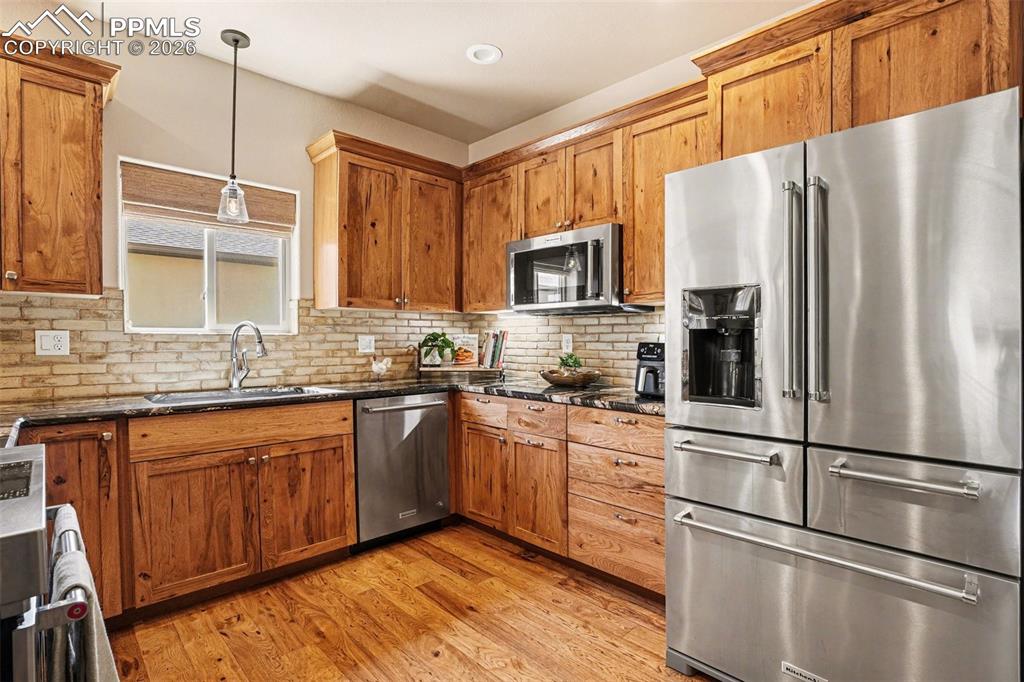 Image 7 of 35: A stylish tile backsplash and premium KitchenAid appliances complete the sp