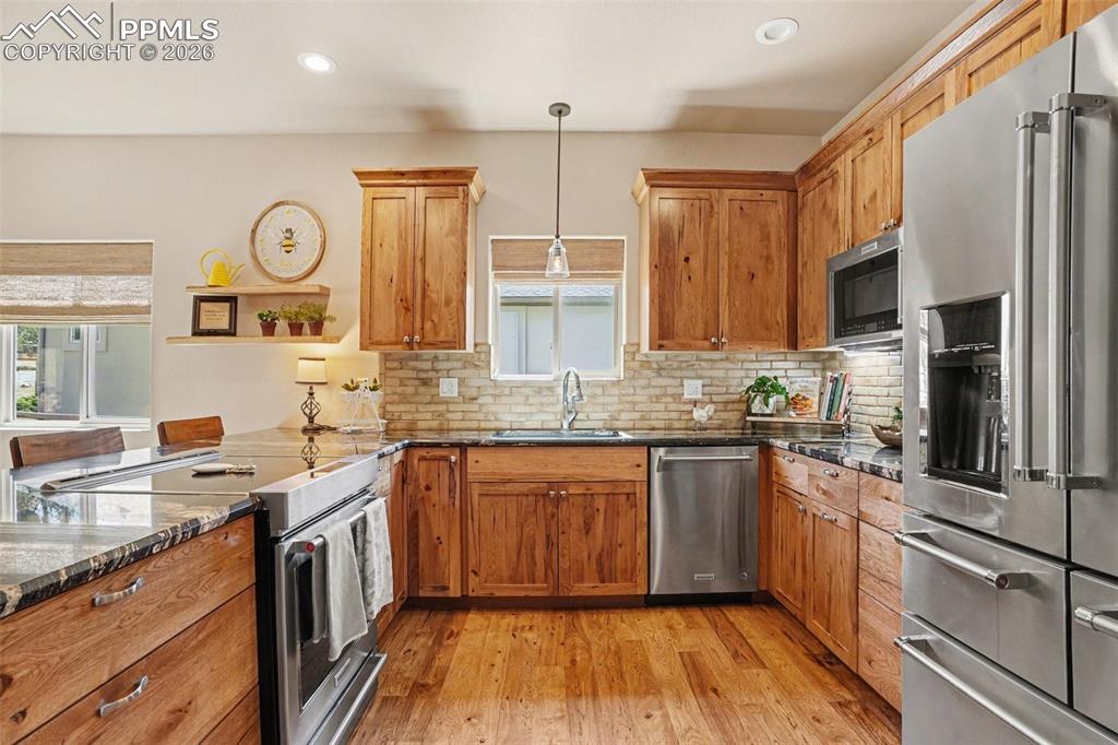 Image 8 of 35: The kitchen is equipped with  the current electric range, while also offeri