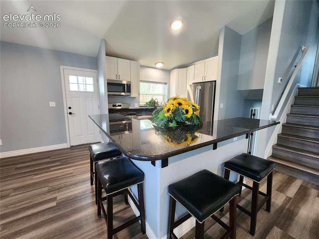 Image 12 of 49: Cozy breakfast bar area ideal for morning coffee or quick meals