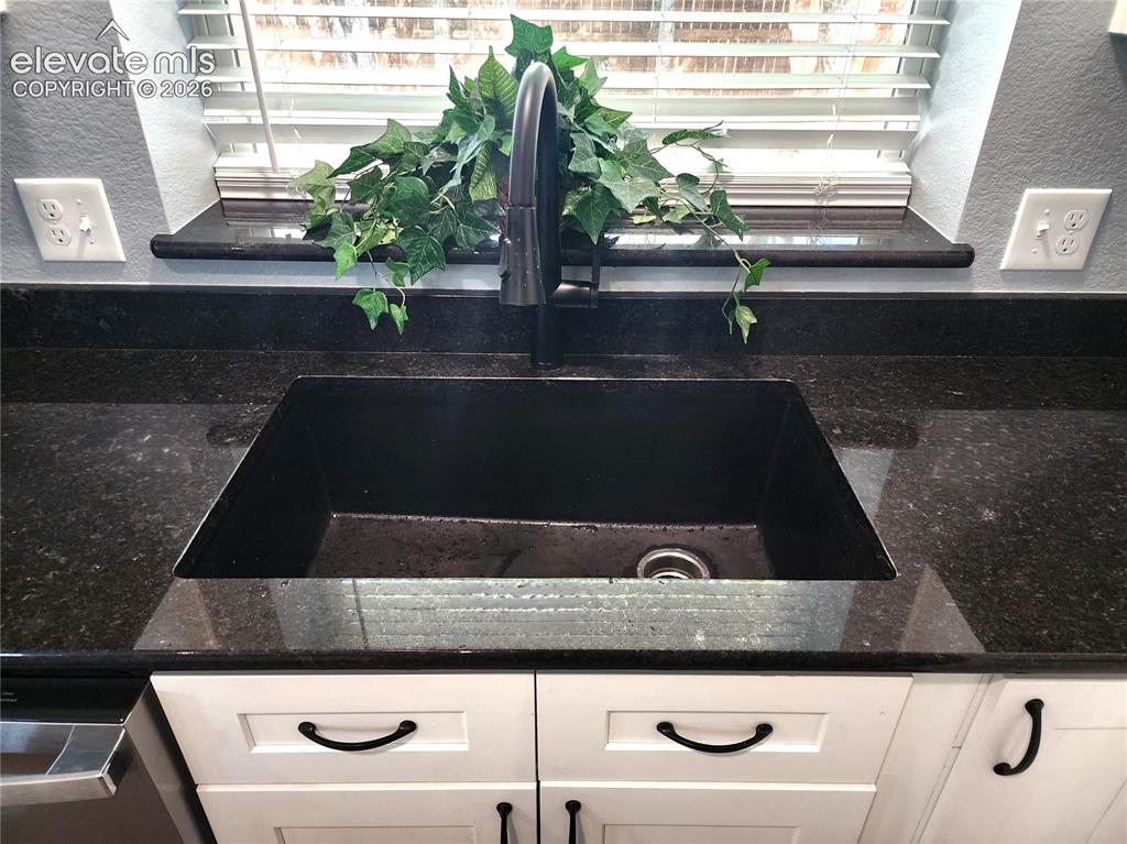 Image 14 of 49: Premium deep basin sink paired with a bright backyard view