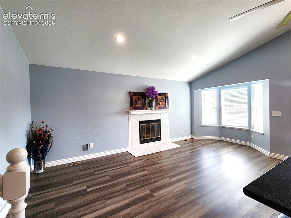 Image 20 of 49: Sun-drenched family room featuring large windows and a cozy abiance