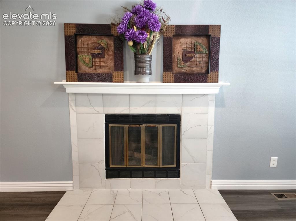 Image 21 of 49: Classic focal-point fireplace complete with a clean, timeless mantel