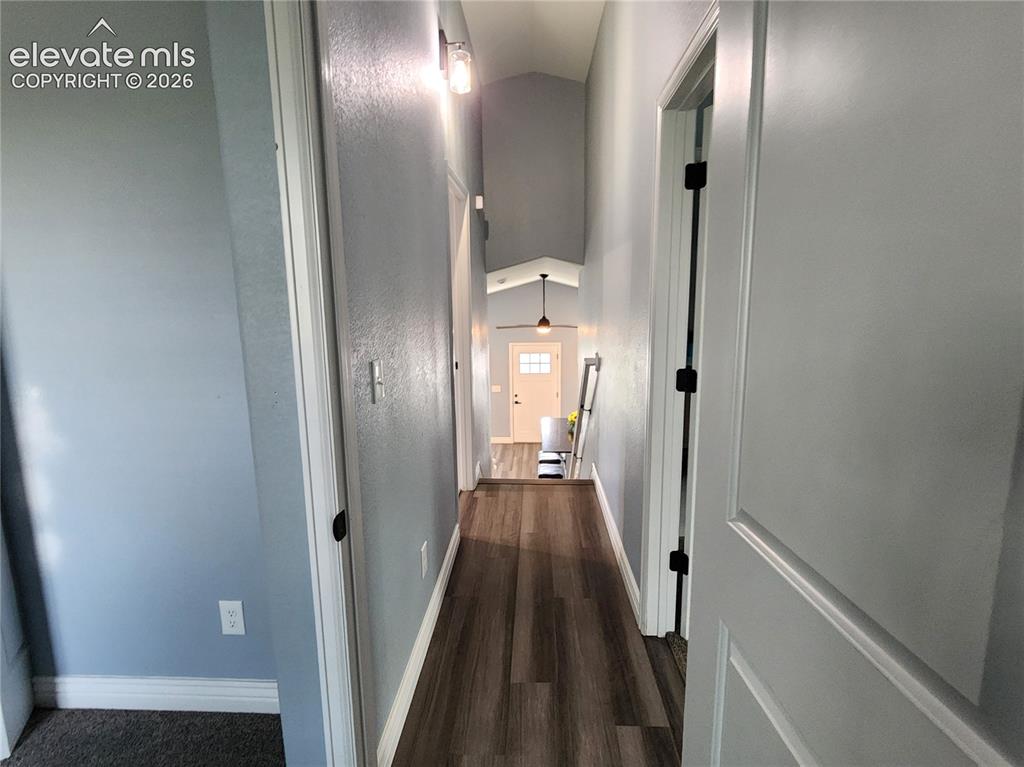 Image 23 of 49: Bright upper-level hallway connecting the bedrooms and baths