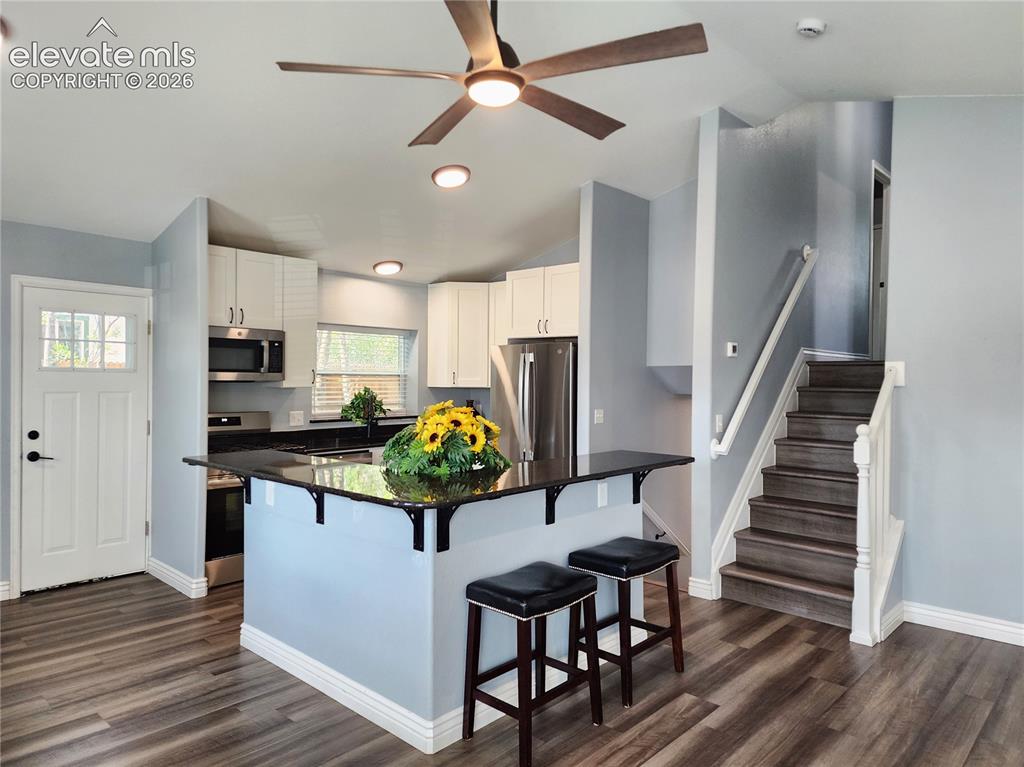 Image 3 of 49: Stylish central island offers the perfect setup for casual dining and enter