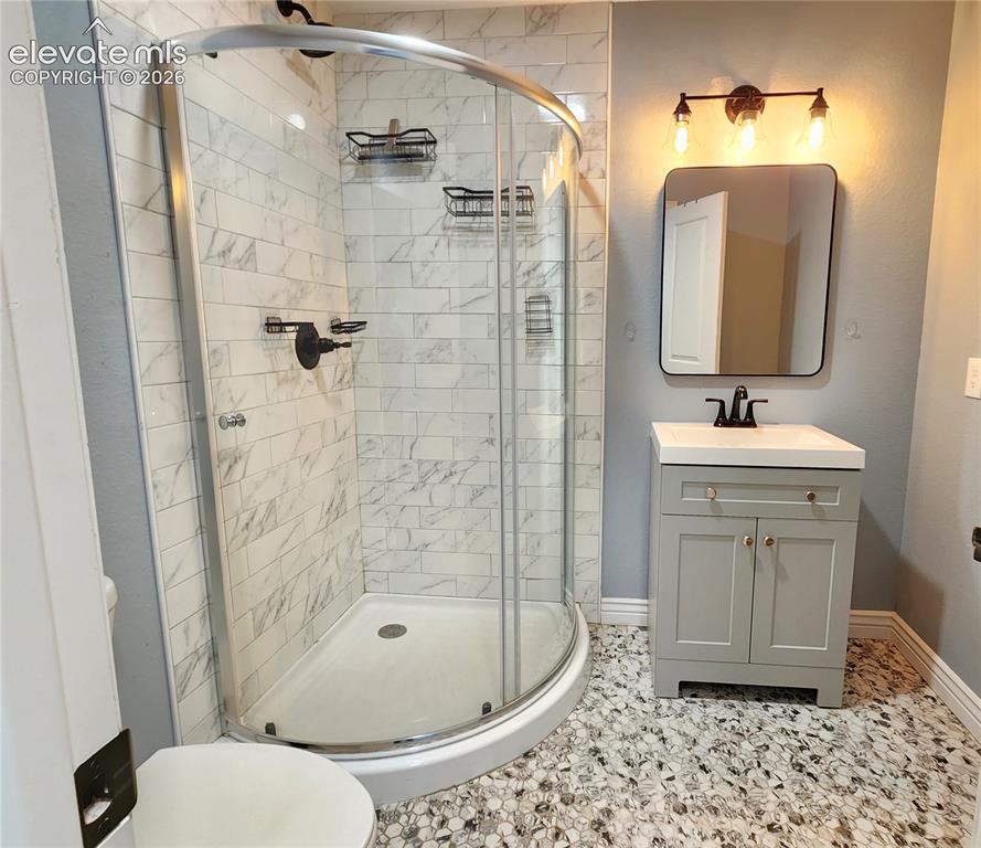 Image 36 of 49: Modern lower-level bathroom boasting a premium corner glass shower and patt
