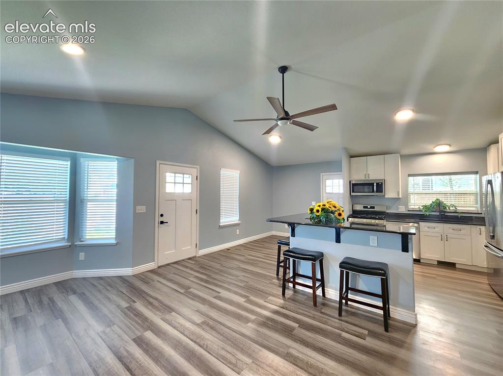 Image 4 of 49: Bright open-concept layout seamlessly connecting the main living area to th