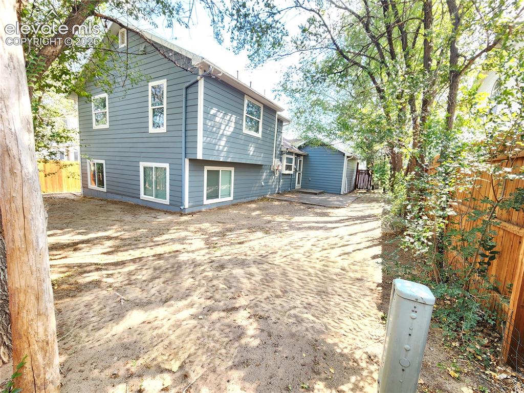 Image 41 of 49: Expansive backyard space offering privacy and room to play or entertain