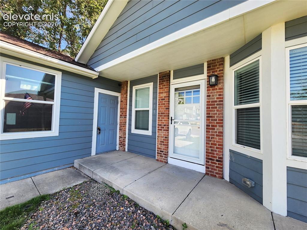 Image 45 of 49: Covered front entry welcoming guests with clean lines and inviting details