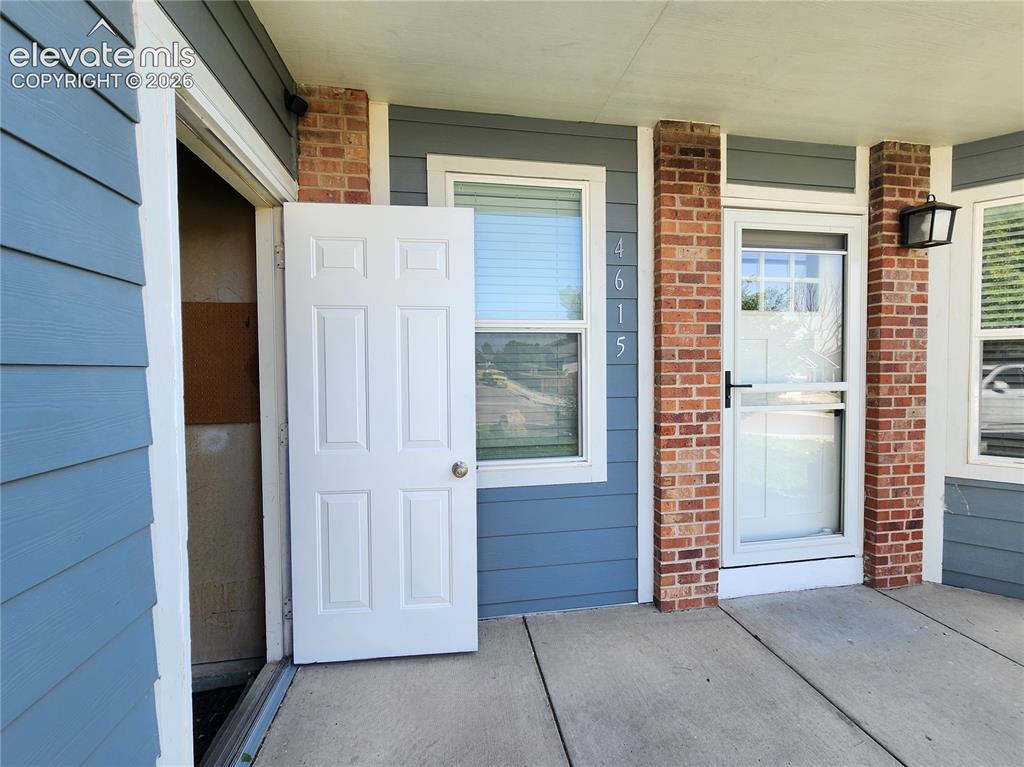 Image 46 of 49: Convenient covered entry highlighting seamless access between the garage si
