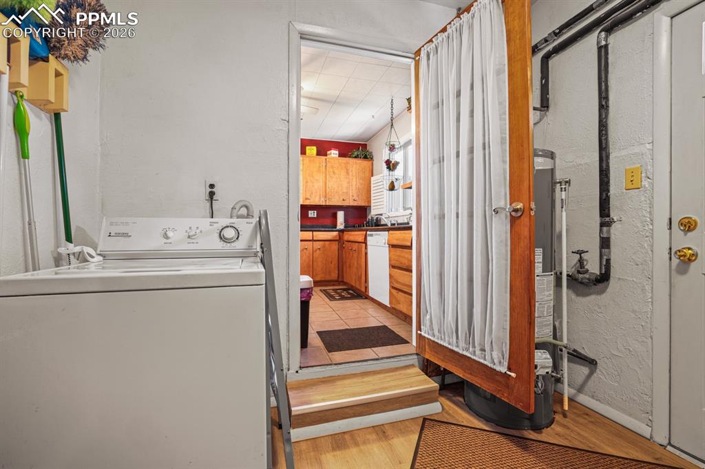 Image 14 of 27: Laundry Room with Kitchen access.
