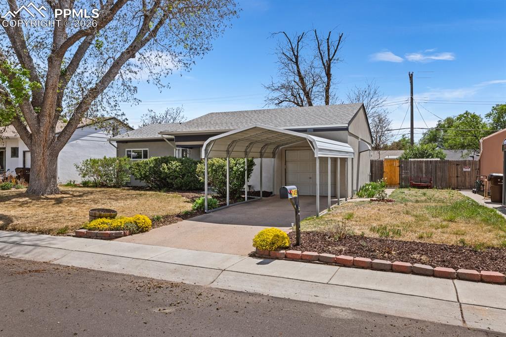 Image 2 of 27: Extra long 1-car garage with additional 1-car carport for parking and stora