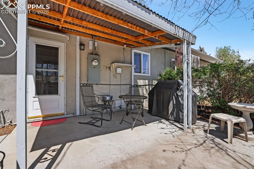 Image 22 of 27: Covered patio and concrete walk way.