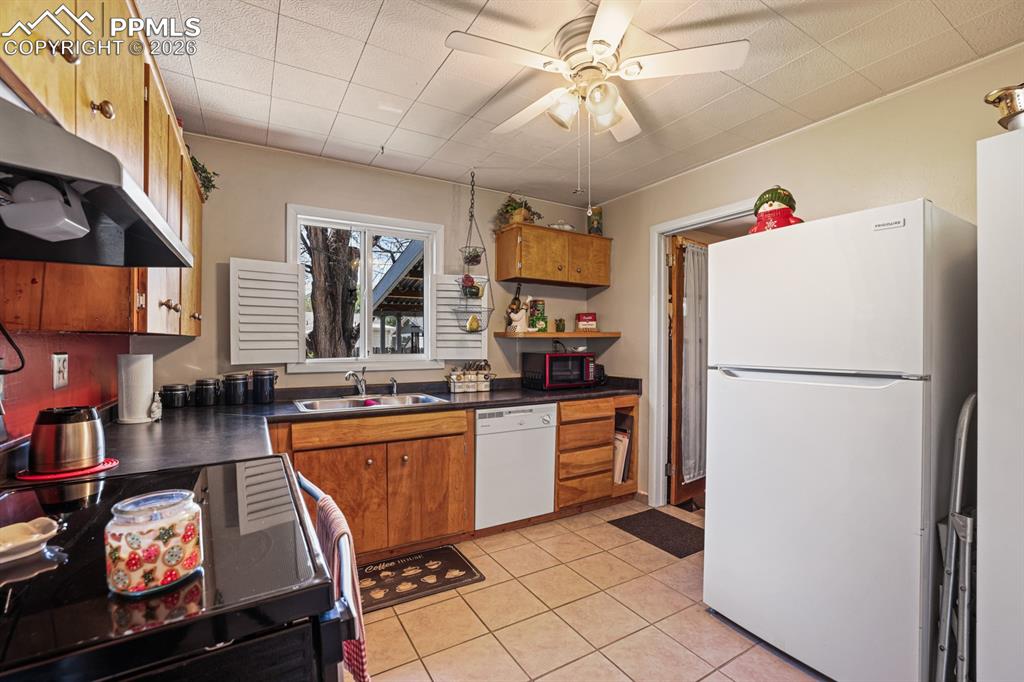 Image 9 of 27: Appliances include a smooth top range oven, vent hood, dishwasher, and refr