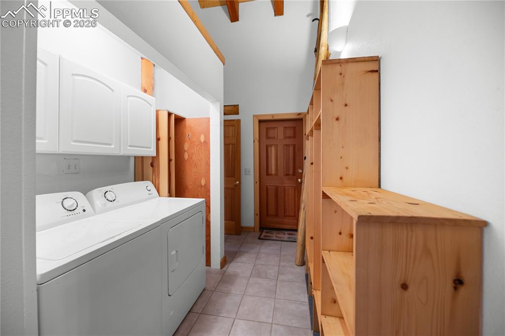 Image 19 of 45: Laundry room featuring cabinet space, washer and clothes dryer, and light t