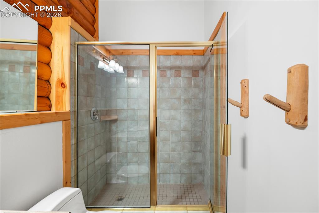 Image 28 of 45: Bathroom featuring toilet and a shower stall