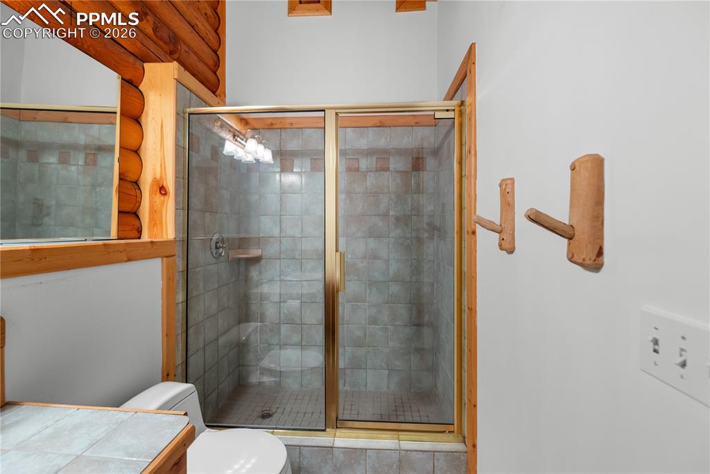 Image 34 of 45: Full bathroom featuring toilet and a stall shower