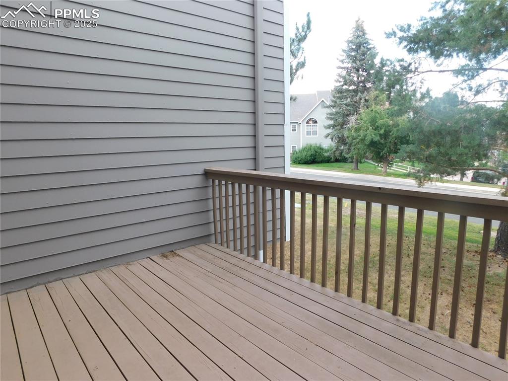 Image 16 of 48: Wooden terrace featuring a yard