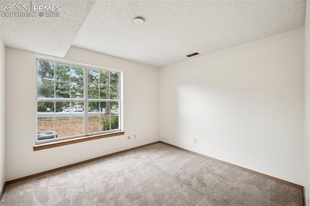 Image 26 of 48: room featuring carpet and a textured ceiling