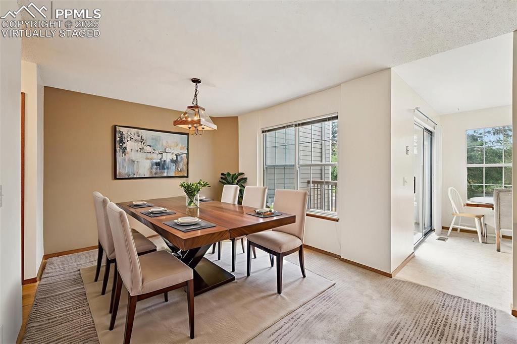 Image 7 of 48: virtually staged - Dining area featuring baseboards and a chandelier