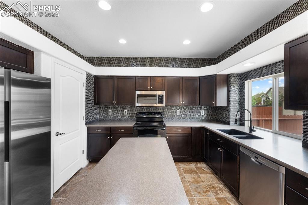 Image 11 of 50: Spacious Kitchen with Pantry and Walkout