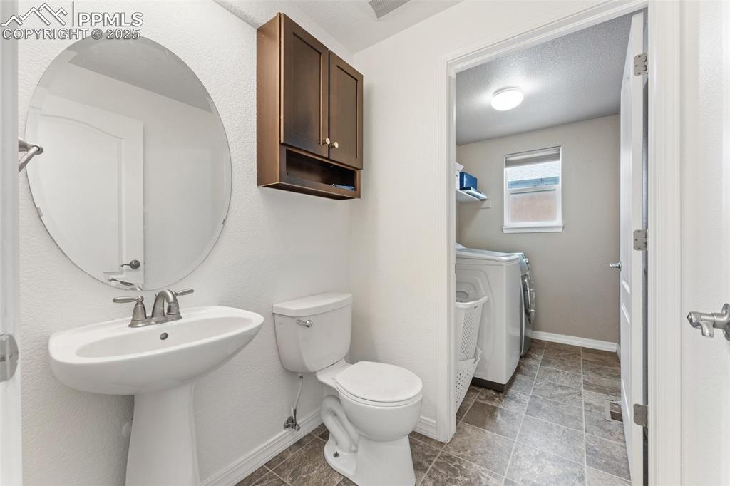 Image 17 of 50: Main Level Half-Bath and Laundry Room 
