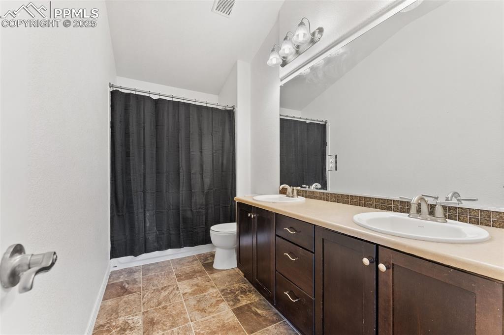 Image 28 of 50: Upper Level Full Bath with High Ceilings and Dual Vanity